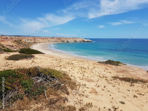 Outlook over sand dunes to the sandy beach and coastline photo