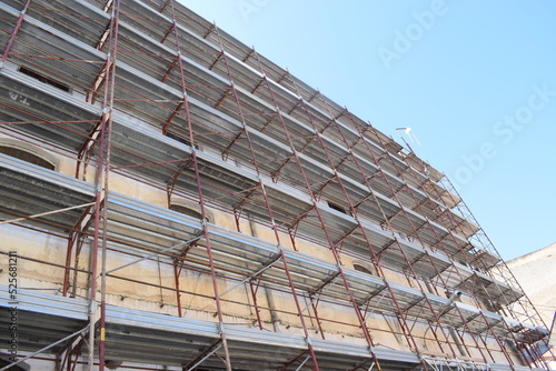 High-rise building in partinico, with construction scaffolding photo