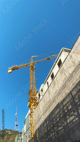 Construction of new buildings with a crane. Tower crane in Tbilisi, Georgia