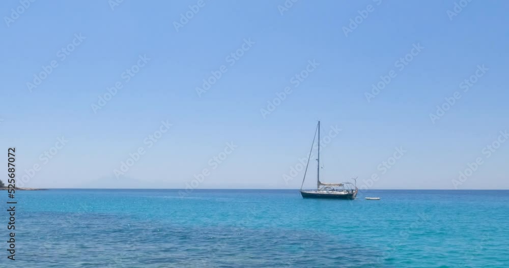 Amazing view of clear turquoise color of sea, seascape with yacht at bay, pleasure of sailing. Clear blue sky on a sunny day. Summer travel holidays concept. Slow motion 4K footage. Amazing view of clear turquoise color of sea, seascape with yacht at bay, pleasure of sailing. Clear blue sky on a sunny day. Summer travel holidays concept. Slow motion 4K footage.