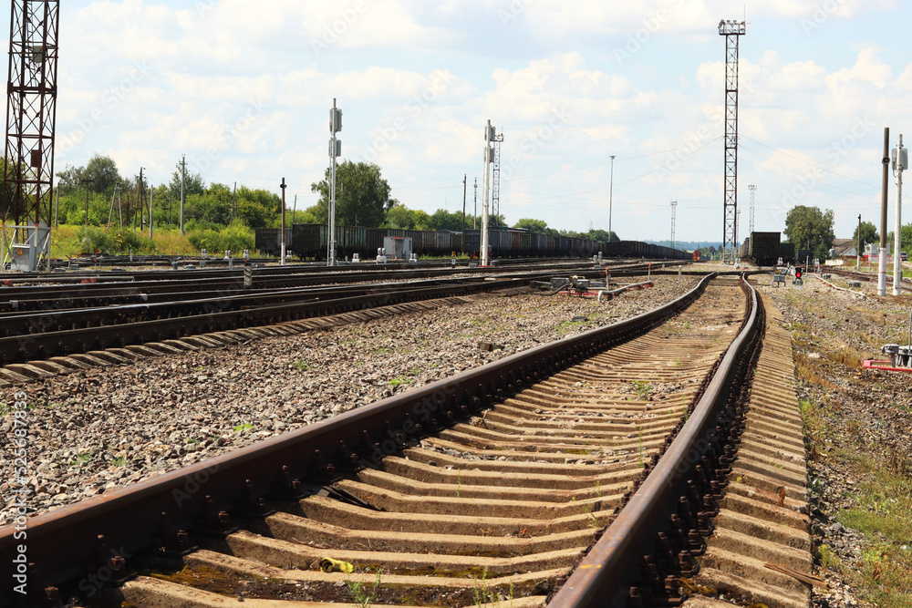 Fototapeta premium Railway tracks in the courtyard of the station. Outdated old freight train. selective focus