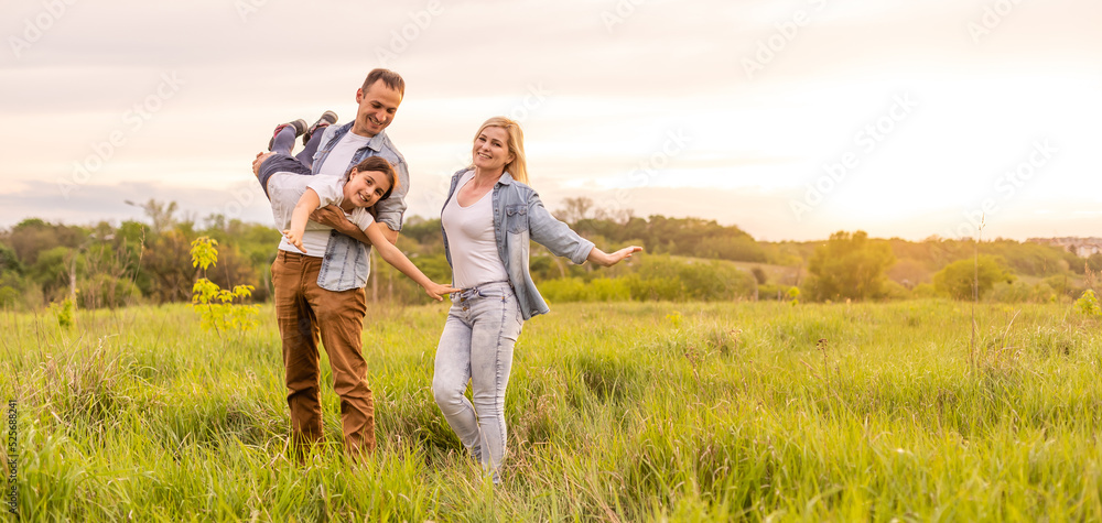 Happy family: mother father and child daughter on nature on sunset Happy family: mother father and child daughter on nature on sunset