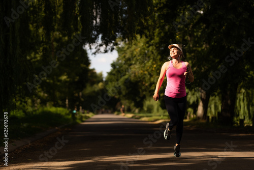 Wallpaper Mural young fitness woman runner athlete running at road Torontodigital.ca