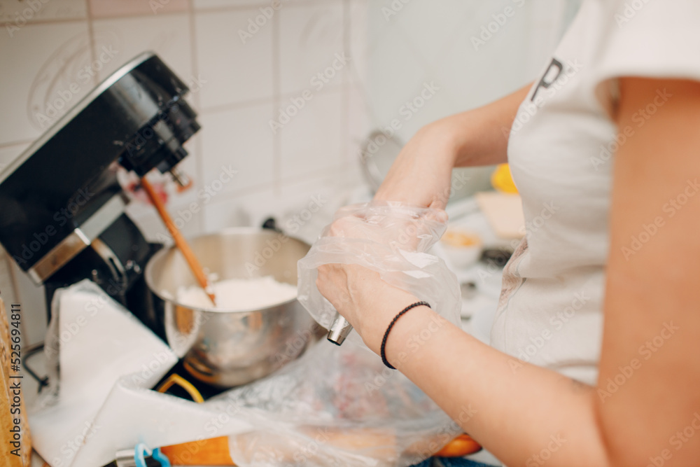 Pastry chef spreads cream and makes delicious red velvet cake. Cooking and decorating dessert. Pastry chef spreads cream and makes delicious red velvet cake. Cooking and decorating dessert.