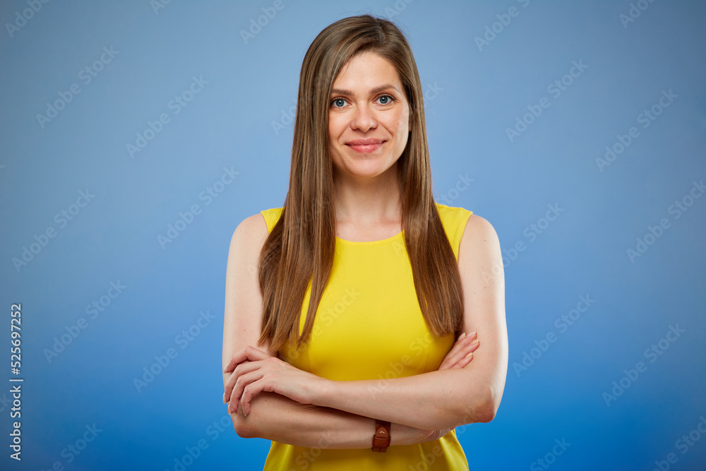 Smiling woman in yellow casual dress. Isolated female portrait on blue background. Smiling woman in yellow casual dress. Isolated female portrait on blue background.