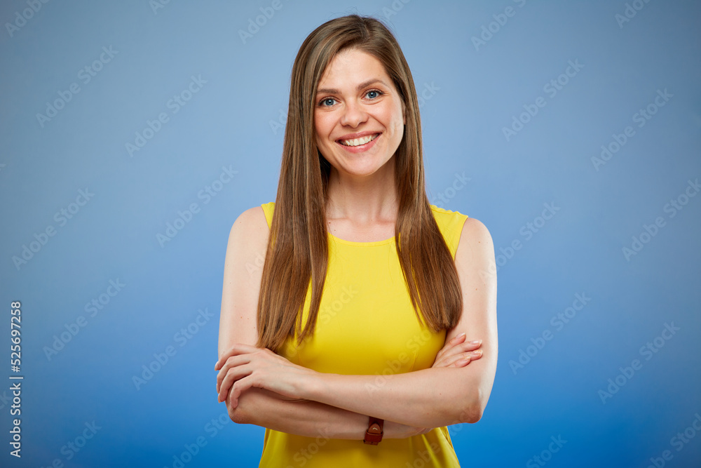 Young smiling woman in yellow casual dress. Isolated female portrait on blue background. Young smiling woman in yellow casual dress. Isolated female portrait on blue background.