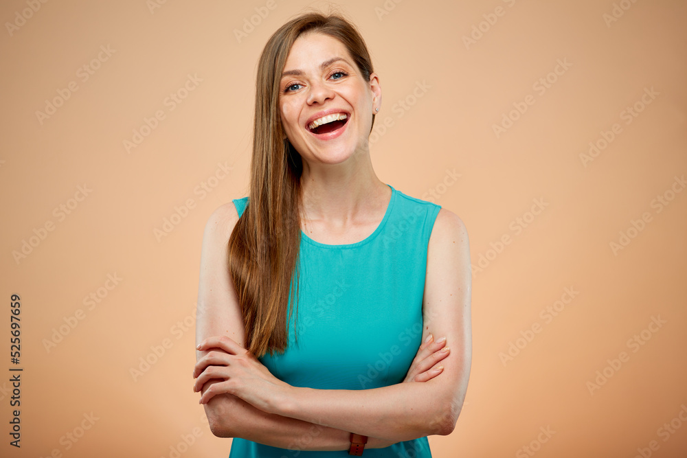 Obraz premium Smiling woman with arms crossed isolated portrait on yellow brown background.