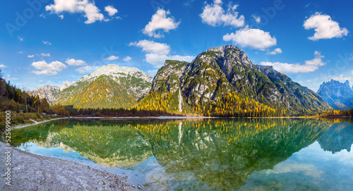 Autumn peaceful alpine lake Durrensee or Lago di Landro. Snow-capped Cristallo rocky mountain group behind, Dolomites, Italy, Europe. Seasonal and nature beauty concept. People and cars unrecognizable photo