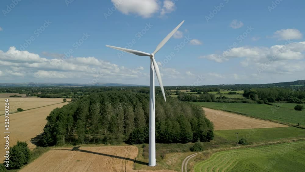 Aerial mid aspect level clip of a wind turbine in a small rural wind farm in the English countryside Aerial mid aspect level clip of a wind turbine in a small rural wind farm in the English countryside