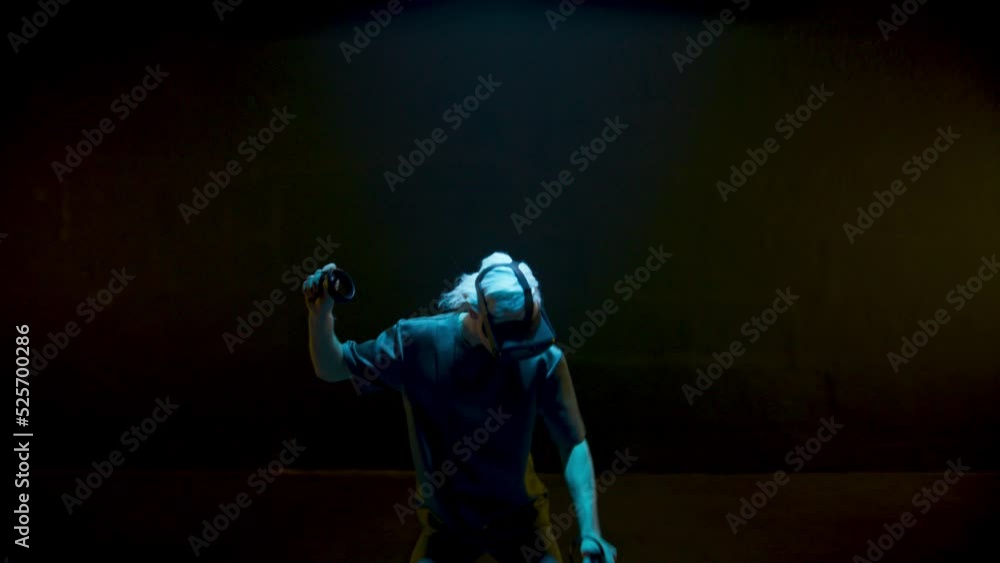 Cyber man playing vr game in neon lights. Excited gamer enjoying augmented Cyber man playing vr game in neon lights. Excited gamer enjoying augmented