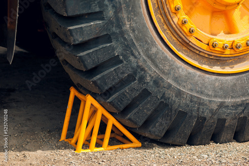 Yellow wheel stopper for stopping the wheel dump truck moving