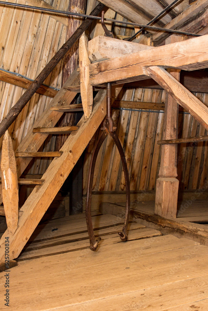 Old mill interior with vintage equipment and wooden staircase