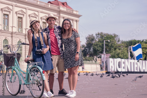 Portrait of young Hispanic tourists with bicycles in the central park in El Salvador.