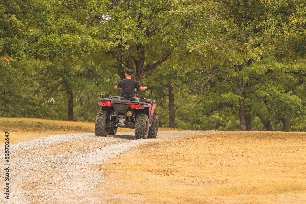 Fototapeta premium young male person riding an atv
