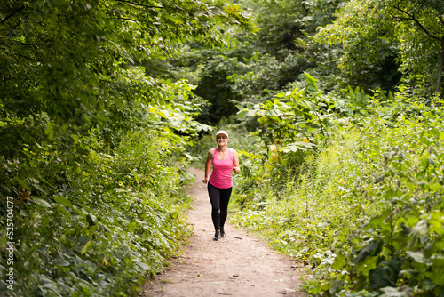 healthy lifestyle fitness sporty woman runner running in forest trail