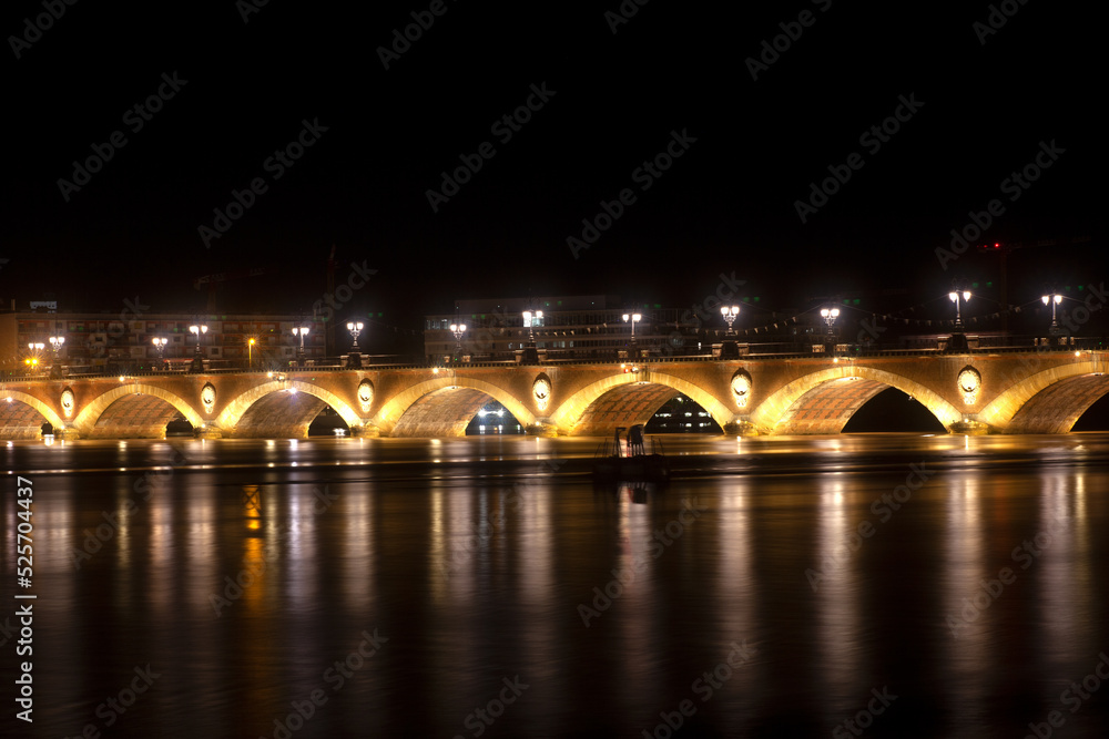 Night view of the famous bridge of Bordeaux called Le Pont de Pierre