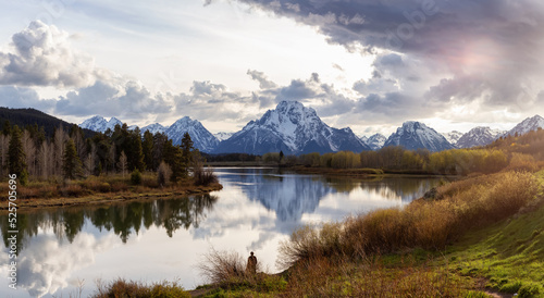 River surrounded by Trees and Mountains in American Landscape. Snake River, Oxbow Bend. Spring Season. Grand Teton National Park. Wyoming, United States. Nature Background Panorama. Sunset Cloudy Sky