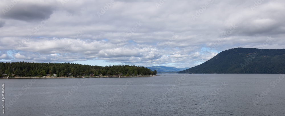 Treed Island with Homes and docks, surrounded by other islands. Summer Season. Gulf Islands near Vancouver Island, British Columbia, Canada. Canadian Landscape.