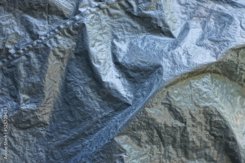 plastic texture of black cellophane on a crumpled bag