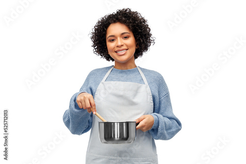 Photos culinary and people concept - happy smiling woman in apron with saucepan cooking