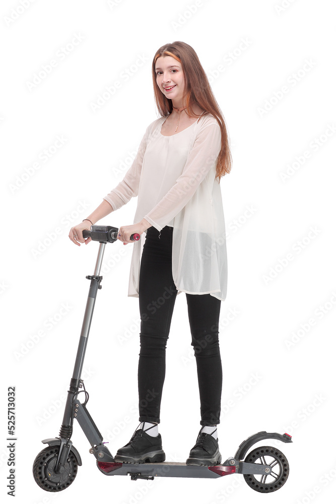 Young happy woman is standing a back near her kick scooter Young happy woman is standing a back near her kick scooter