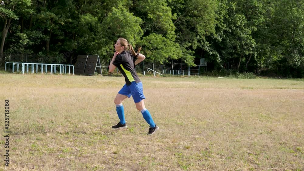 girl football player under the bright sunny sun hits the ball and runs after it girl football player under the bright sunny sun hits the ball and runs after it