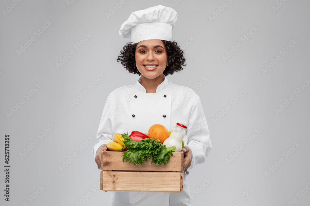 cooking, culinary and people concept - happy smiling female chef in toque  holding food in wooden box over grey background Stock Photo | Adobe Stock