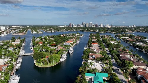 Flying over houses at Harbor Beach in Fort Lauderdale viewing the city skyline in Florida.