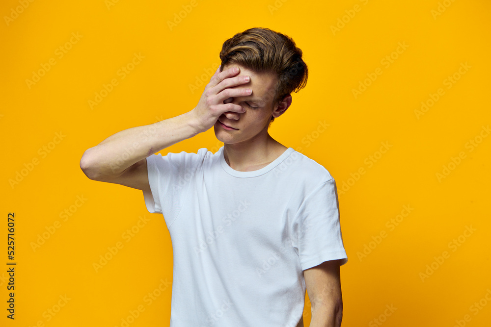 a man in a white t-shirt has a headache a man in a white t-shirt has a headache