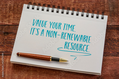 value your time, it's a non-renewable resource, writing in a spiral notebook against rustic wood, productivity and personal development concept