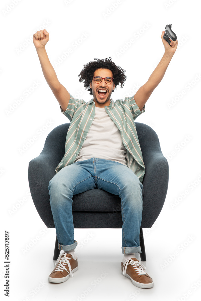 technology, people and leisure concept - happy smiling young man in glasses with gamepad playing video game and celebrating success over white background technology, people and leisure concept - happy smiling young man in glasses with gamepad playing video game and celebrating success over white background