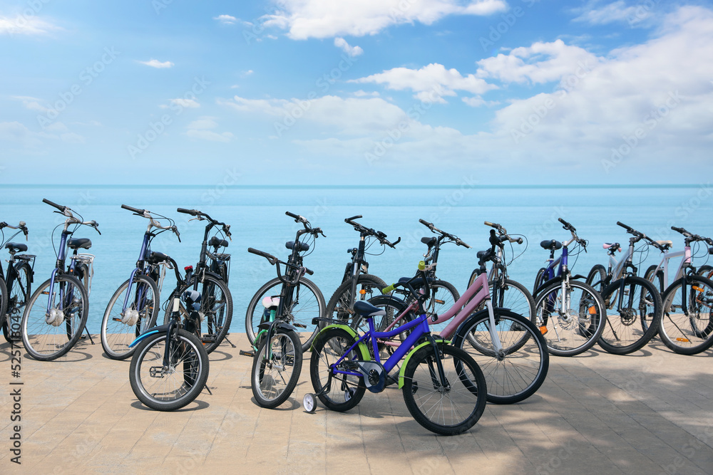 Fototapeta premium Parking with bicycles on embankment near sea