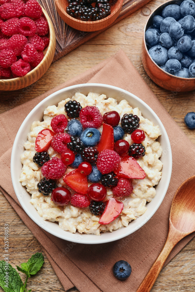 Flat lay composition with tasty oatmeal porridge and ingredients served on wooden table. Healthy meal Flat lay composition with tasty oatmeal porridge and ingredients served on wooden table. Healthy meal