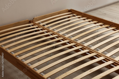 Wooden bed frame on floor in room, closeup view