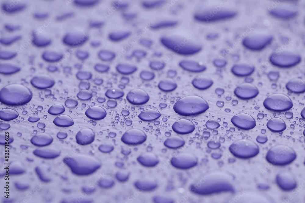 Water drops on lilac background, closeup view Water drops on lilac background, closeup view