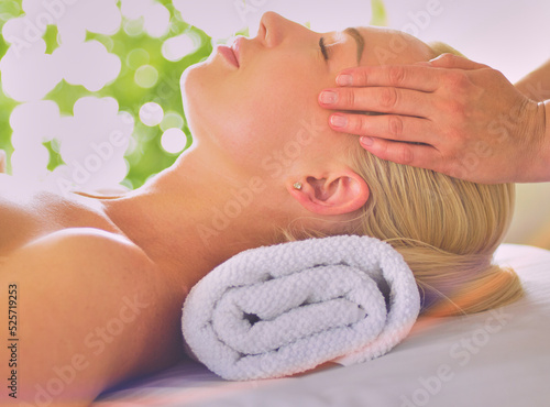 Beautiful woman doing facial massage in a spa salon
