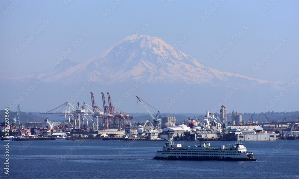 MtRainier dominates the horizon beyond Seattle industrial suburbs