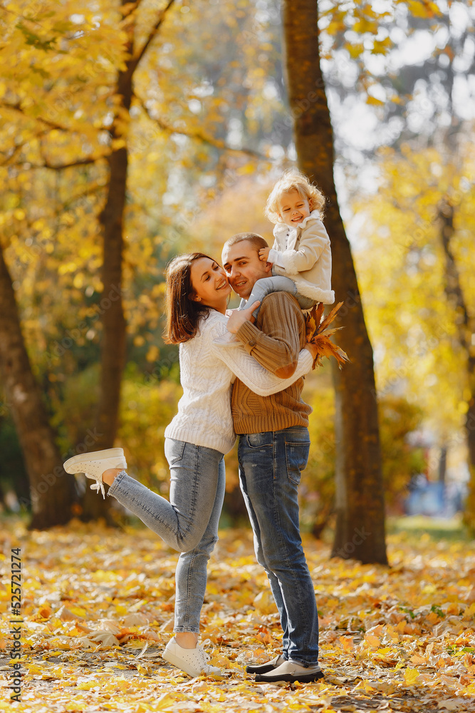 Cute and stylish family playing in a autumn field Cute and stylish family playing in a autumn field