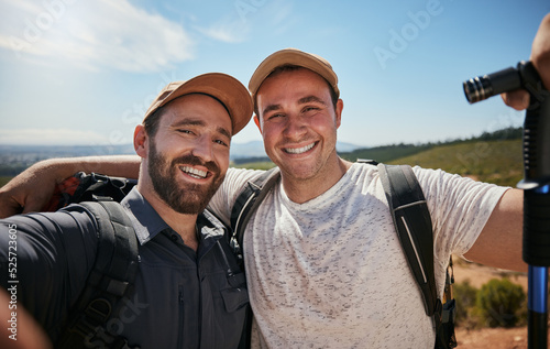 Fototapeta Friends, brothers or hikers taking a selfie while hiking outdoors in nature sharing the experience on social media