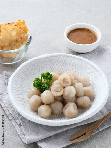Cilok, traditional food from West Java, Indonesia, made from tapioca, chewy textured. Served with peanut sauce. 