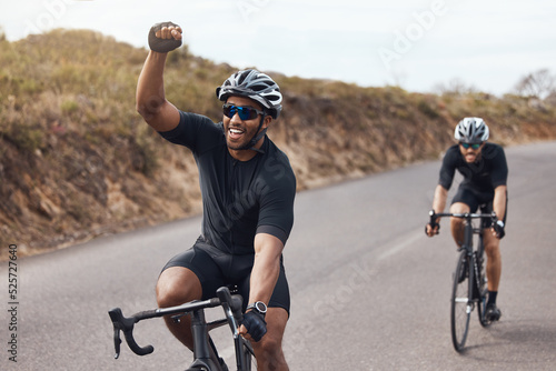 Winner, celebrating and winning cyclist cycling with his friend and racing outdoors in nature. Victory, joy and happy bicycle rider exercising on a bike for his workout routine on the road photo