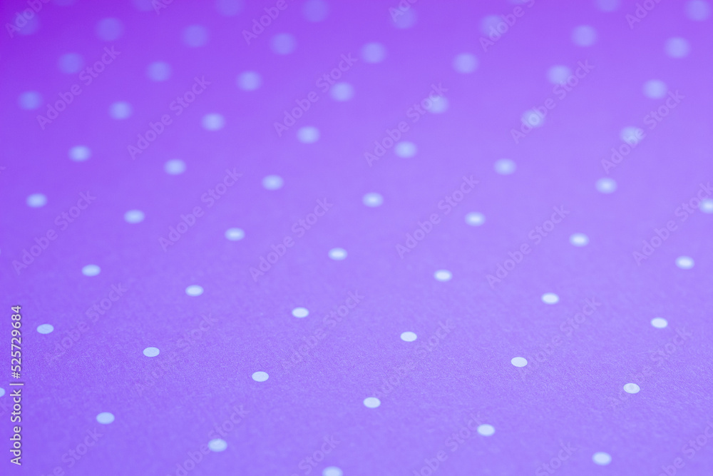 Full frame abstract texture background of solid purple and white polka dots pattern with selective focus