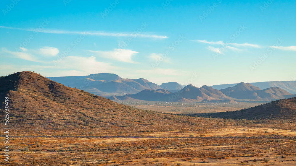 Naklejka premium Sonoran Desert mountains and dirt fields in Phoenix Arizona on an autumn October day