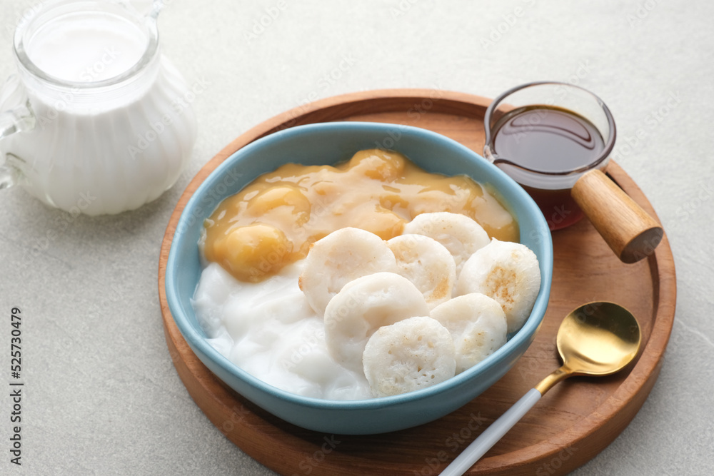 Serabi Bubur Sumsum with Candil Ubi. Indonesian traditional porridge. Served with palm sugar sauce. Sweet and savory. Popular food during ramadhan.
Serabi Bubur Sumsum with Candil Ubi. Indonesian traditional porridge. Served with palm sugar sauce. Sweet and savory. Popular food during ramadhan.
