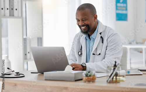 Doctor, medical and healthcare worker on laptop checking history or medical data at hospital or clinic working with tech. GP man on computer reading emails, patient records and documents