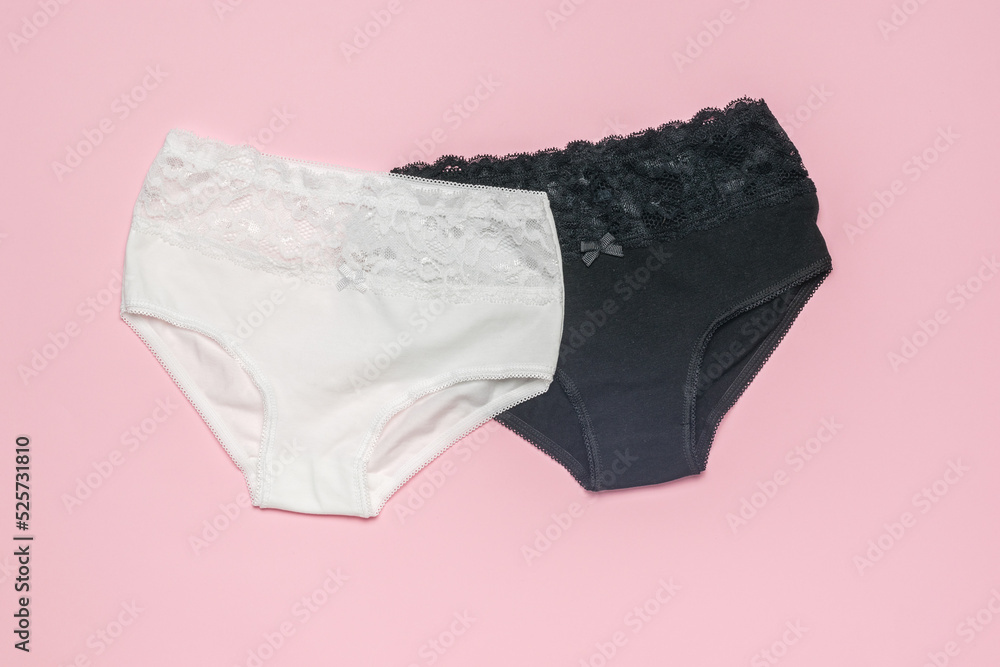 A pair of beautiful women's panties on a light pink background. Minimal concept of women's underwear.