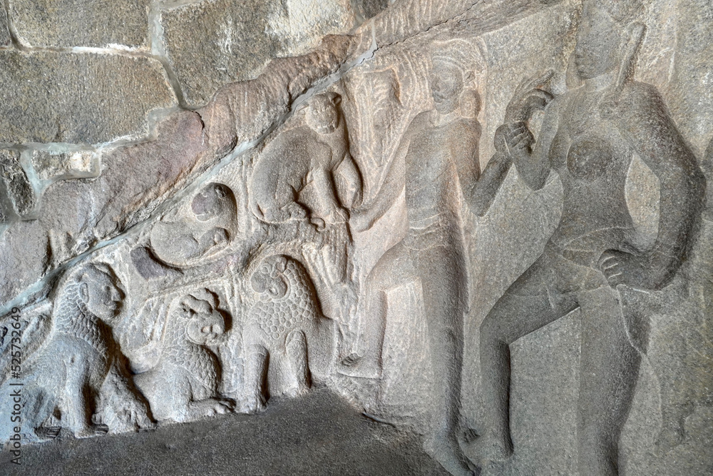 Lion sculpture carved in the monolithic rock cut unfinished ancient cave temples in Mahabalipuram, Tamilnadu. Indian rock art of bas relief animal sculptures at rock cut historical caves in Tamilnadu.