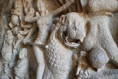 Battlefield scene of Hindu Goddess Durga fight with the Buffalo headed Demon with her army of female warriors is carved as Bas relief sculpture in the rock cut cave temples in Mahabalipuram, Tamilnadu