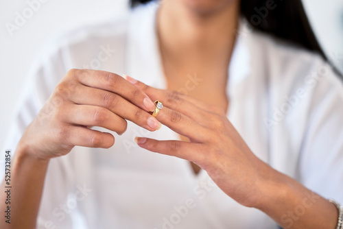 Fototapeta .Woman hand taking off ring or jewelry for divorce and break engagement after fa