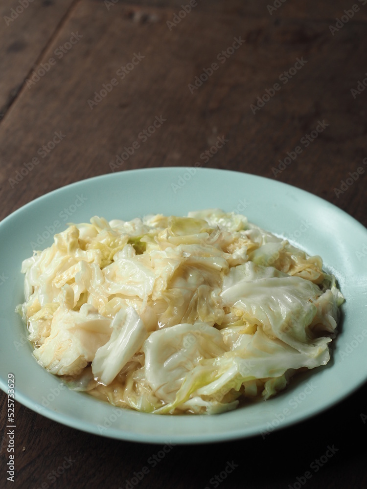 stir fried cabbage with fish sauce on wooden table